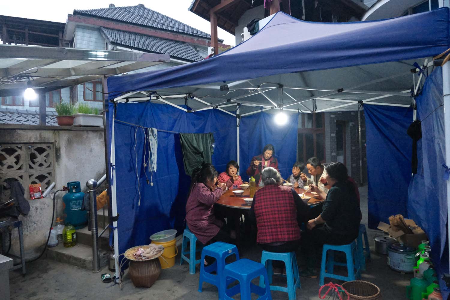 At Zhu Xiaoqing’s home in Meijiawu, tea pickers gather for a simple noodle dinner after a long day in the fields.