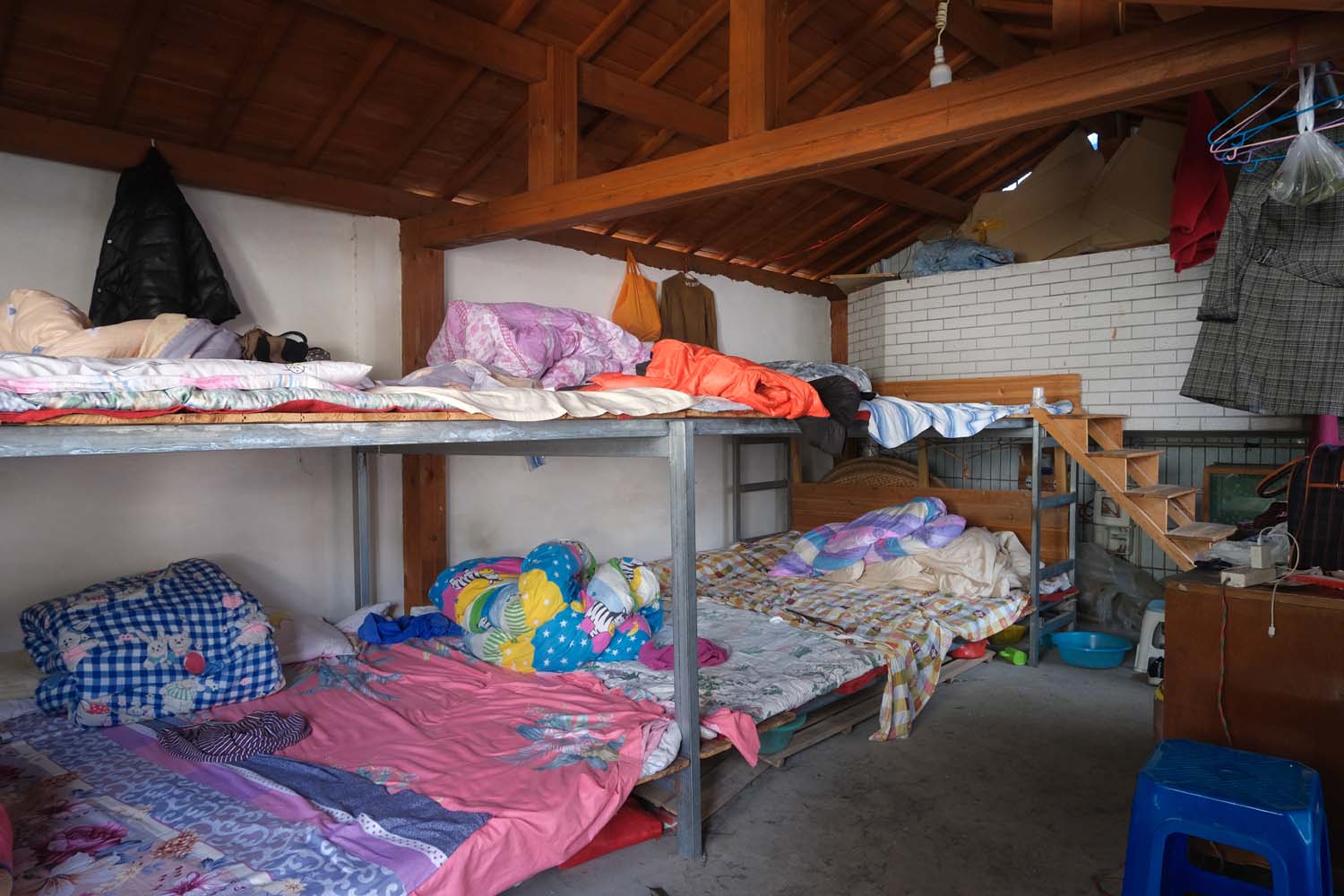 A dormitory for tea pickers, where migrant workers sleep shoulder to shoulder.